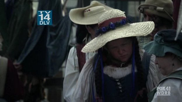 TV 14 warning and station logo over image of a crowd in renaissance faire costumes, the author is facing forward